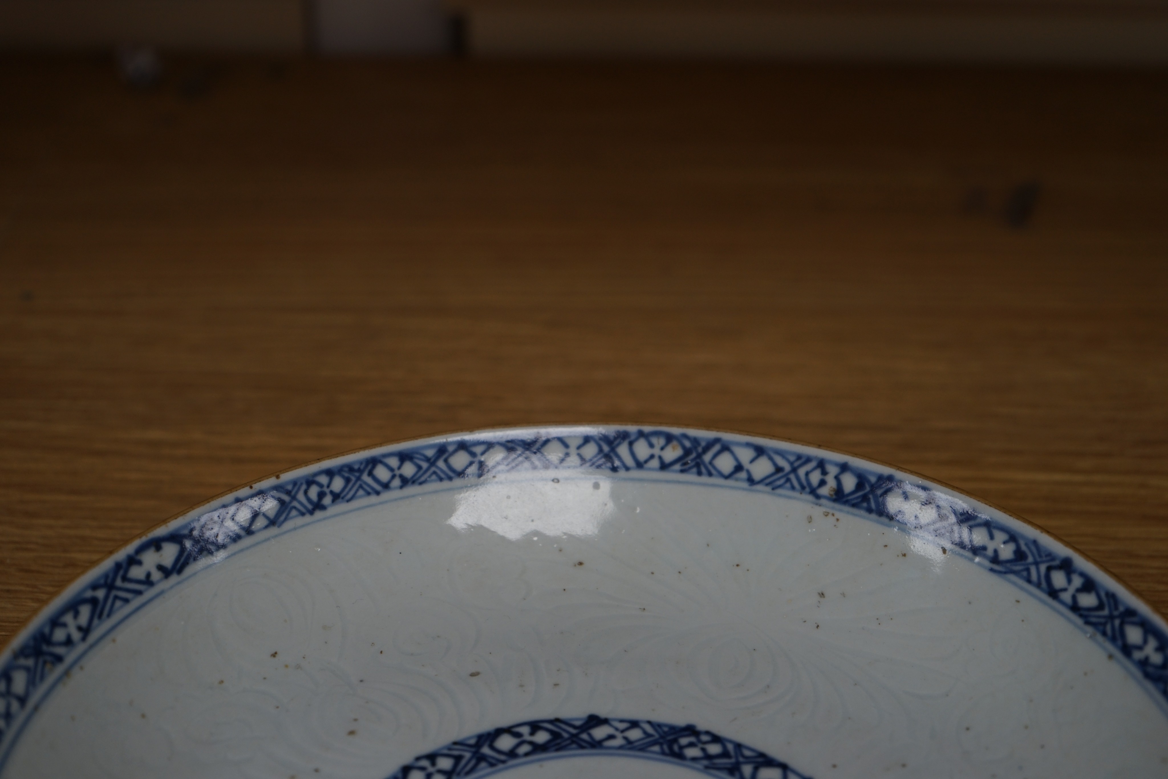 An 18th century Chinese shallow circular blue and white dish with incised decoration, Dia 22cm